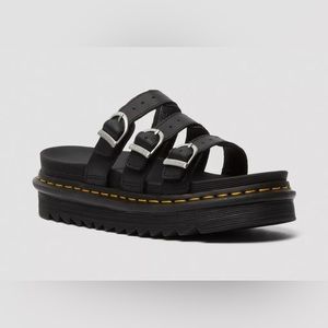 Dr. Martens slide sandal with three leather straps and silver buckles.
